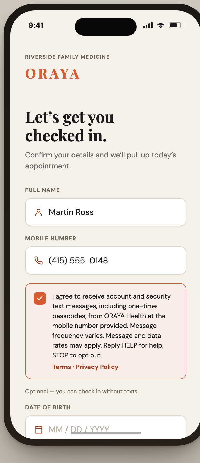 The same check-in screen after the patient has entered their details and affirmatively checked the SMS consent box.